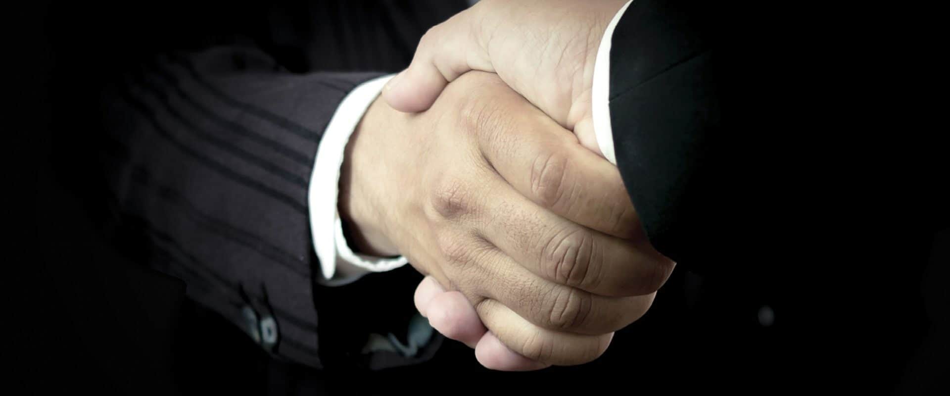 Close-up of two business men shaking hands (Jacob_09/Shutterstock.com)