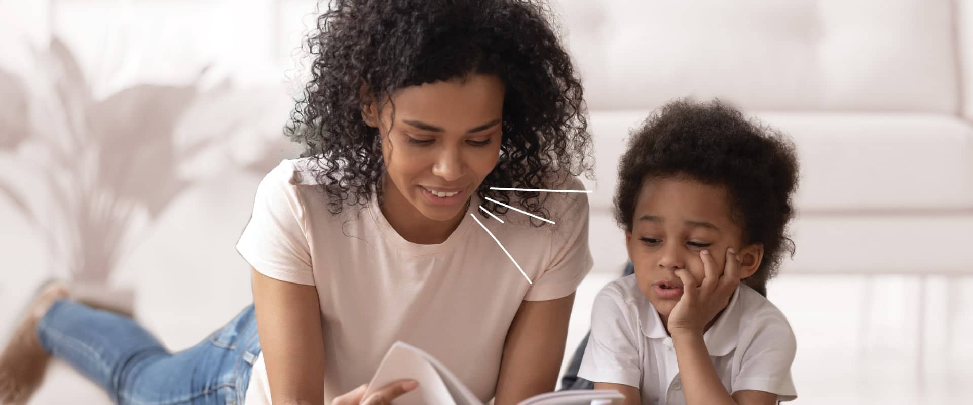 Image of care giver reading to young child (fizkes/Shutterstock.com)