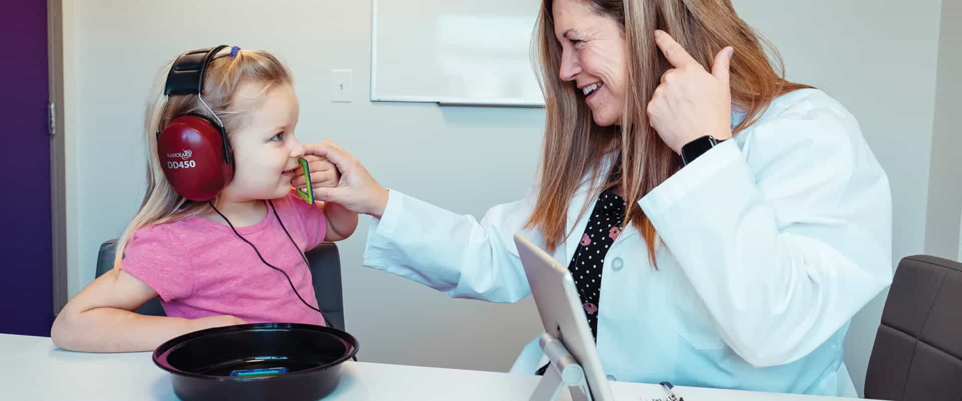 Photo of Audiologist and young patient