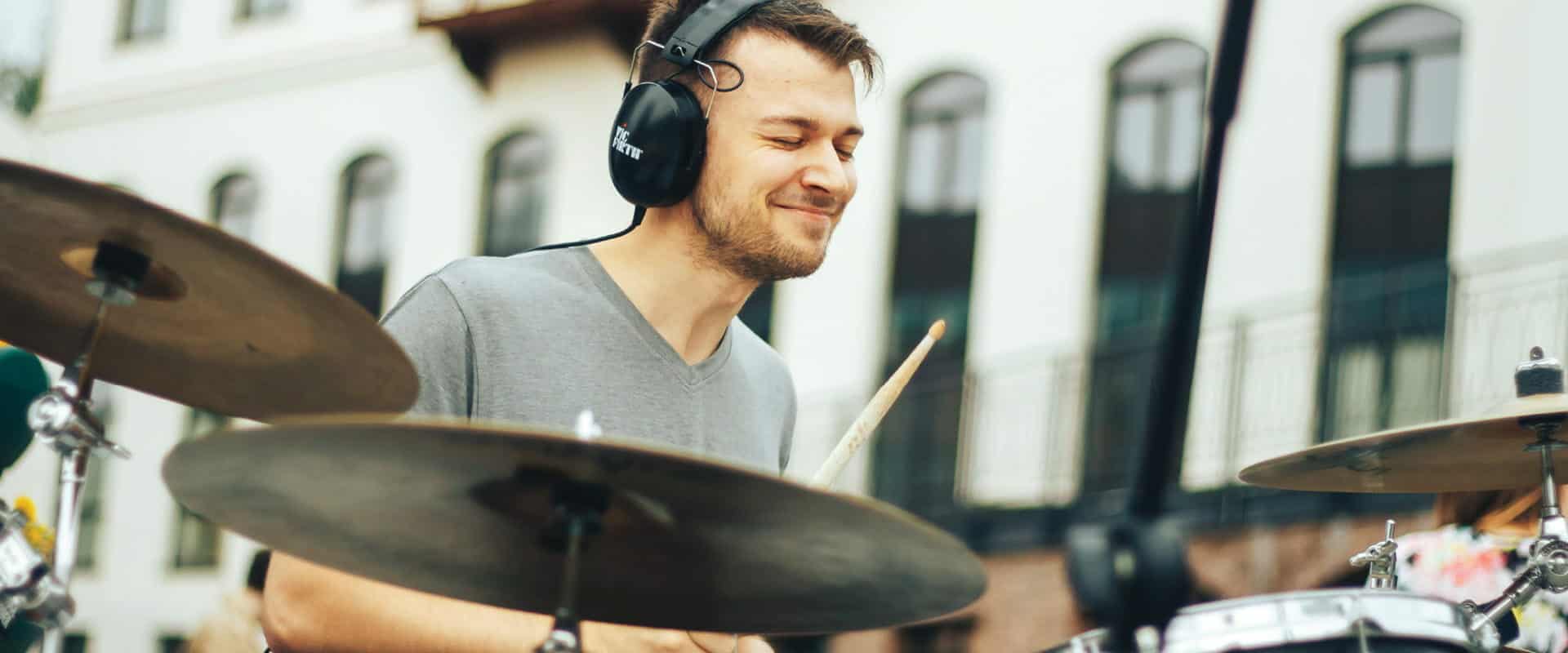 Photo of drummer with protective headgear in a performance