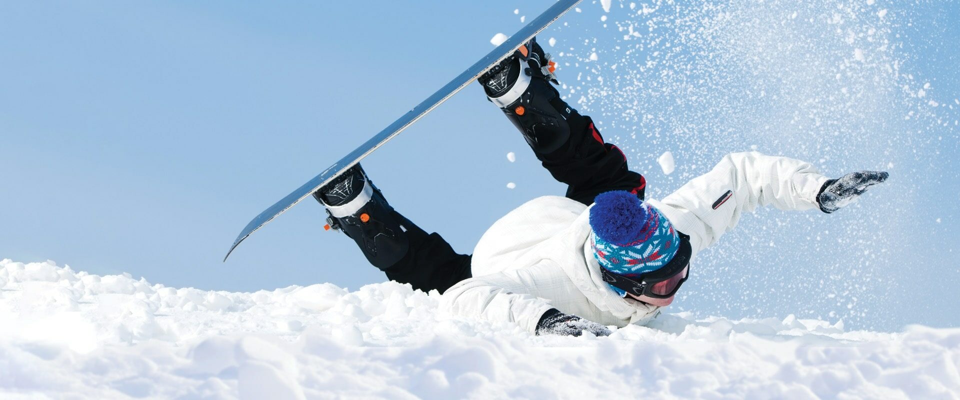 Photo of male snowboarder falling