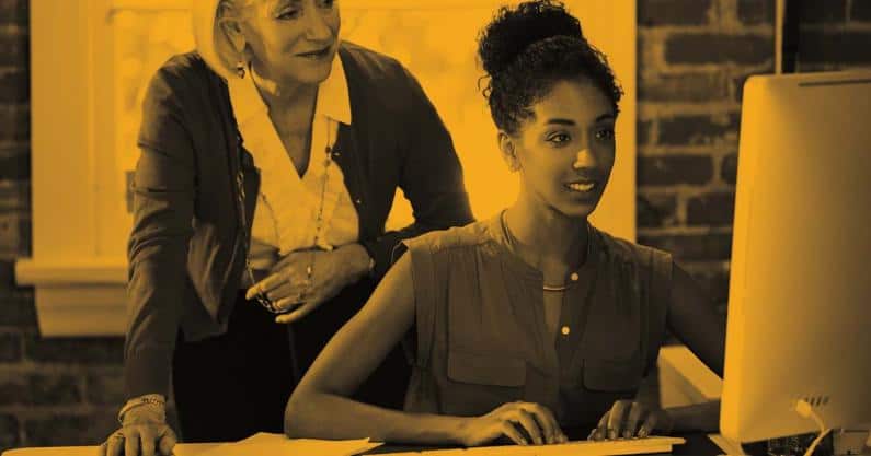 Young woman on computer being mentored in externship