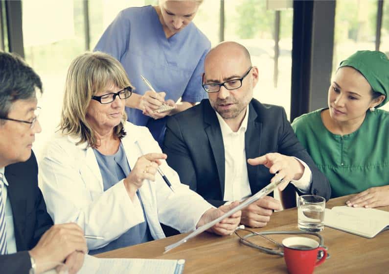 Group of medical professionals consulting a patient's case