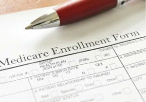 Close-up photo of pen and Medicare enrollment form