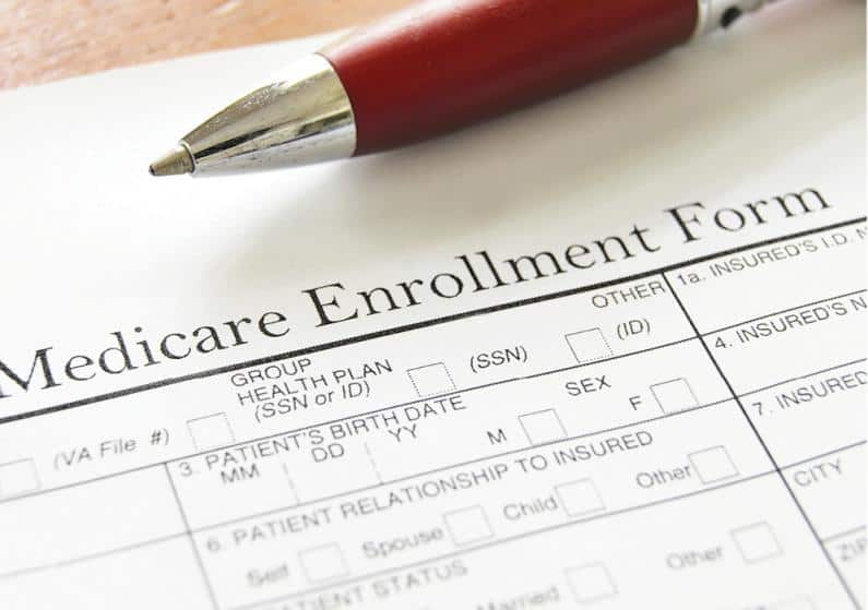 Close-up photo of pen and Medicare enrollment form