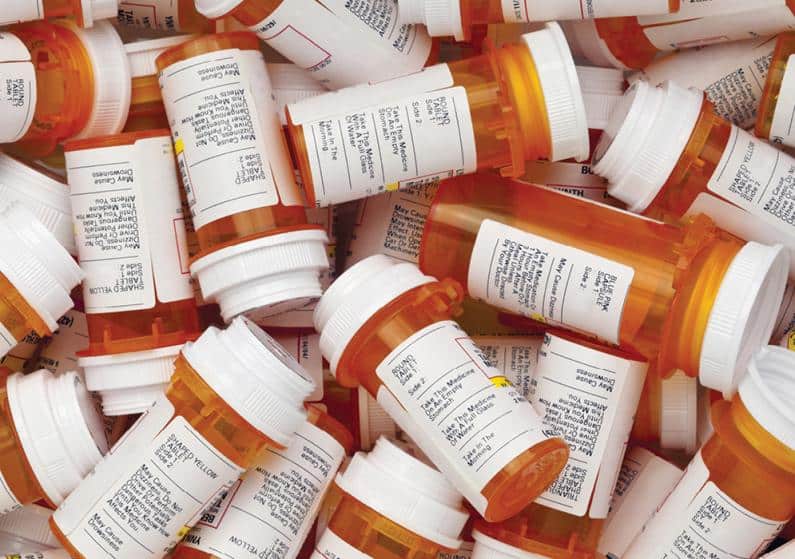 Close-up photo of pile of prescription pill bottles