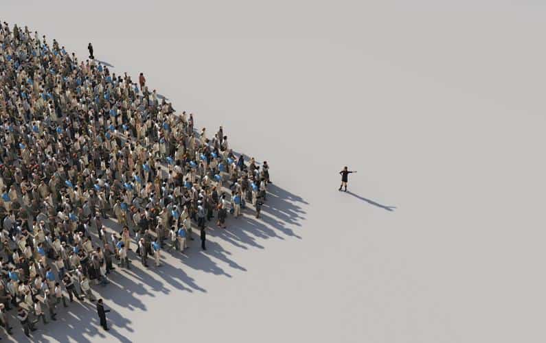 Photo of a crowd of people with a leader leading the way