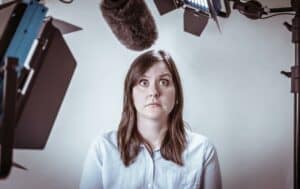 A photograph of a woman appearing to have stage fright during a televised interview