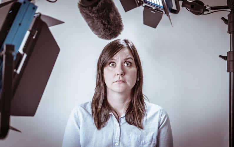 A photograph of a woman appearing to have stage fright during a televised interview