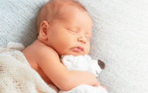 Close-up photo of sleeping baby - How to Effectively Access and Collaborate with Early Hearing Detection and Intervention Systems Article