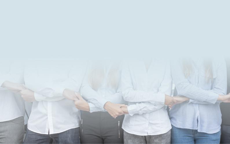 Photo of a group of professionals side by side holding hands