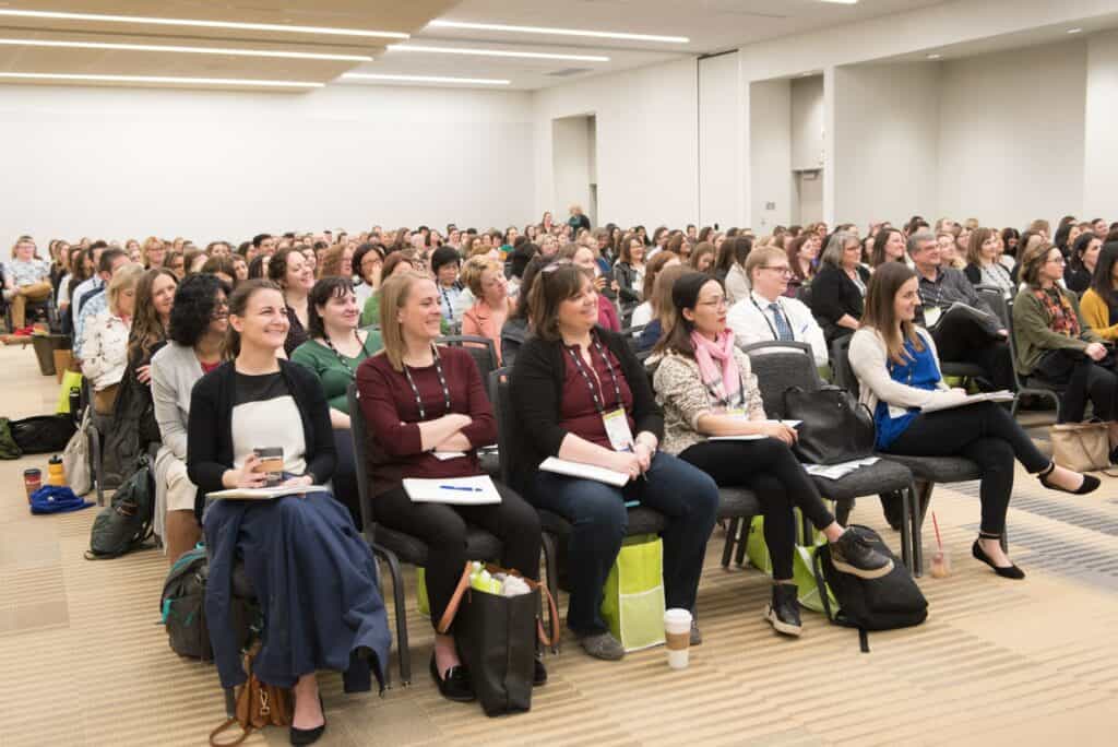 education-and-events-attendees-at-conference-room-academy-2021-06 Conference Attendees Listening to Presentation