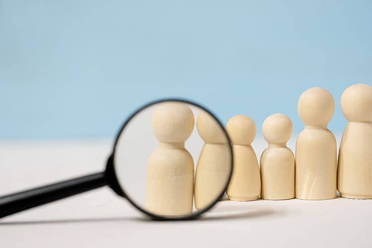 Abstract,Wooden,Figures,Of,People,Under,Black,Magnifying,Glass,On member spotlight program