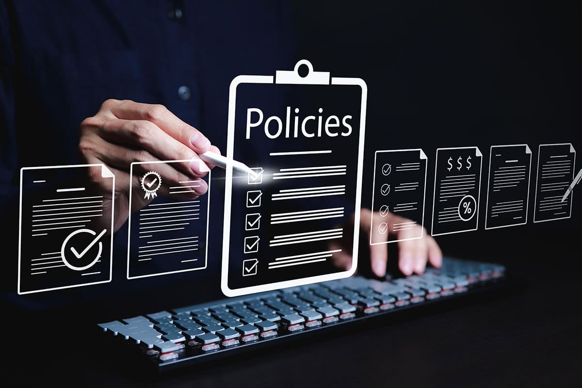Policy documentation and compliance concept. A person reviews digital document labeled "Policies" with icons, checklists, certifications, and financial detail. policy management, regulatory compliance
