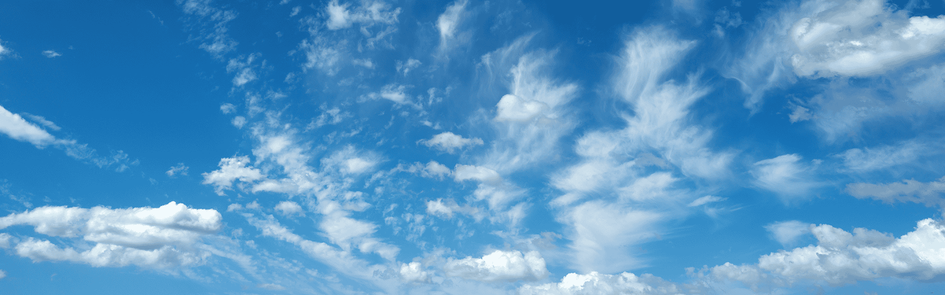 Sun shining through the puffy clouds. Sky view. Beautiful sunny sky. Background with clouds on blue sky. Clouds on blue sky.