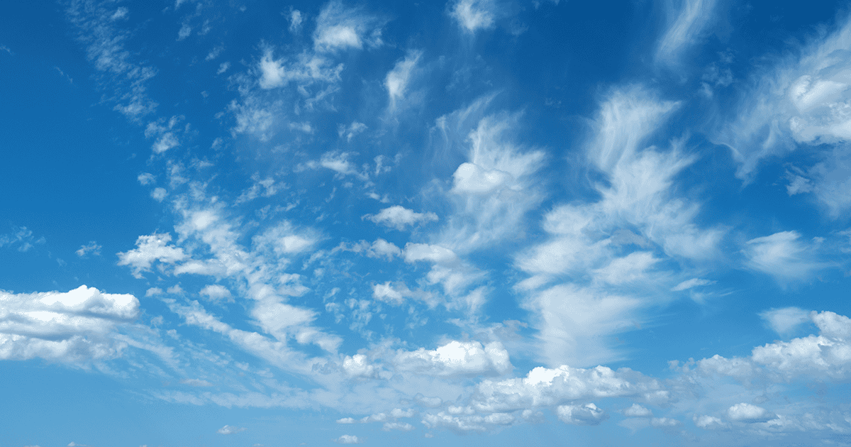 Sun shining through the puffy clouds. Sky view. Beautiful sunny sky. Background with clouds on blue sky. Clouds on blue sky.