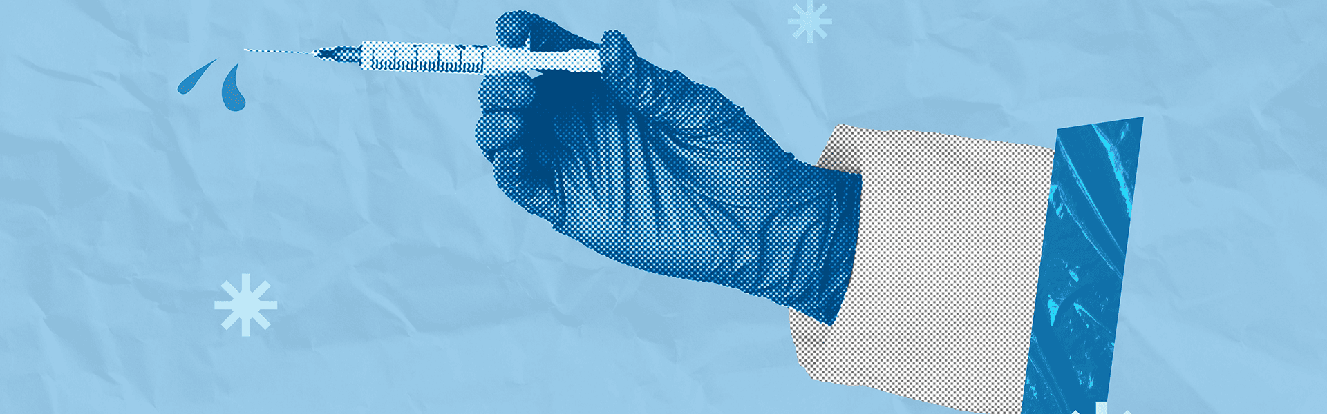 Hand wearing latex glove holding syringe filled with vaccine.