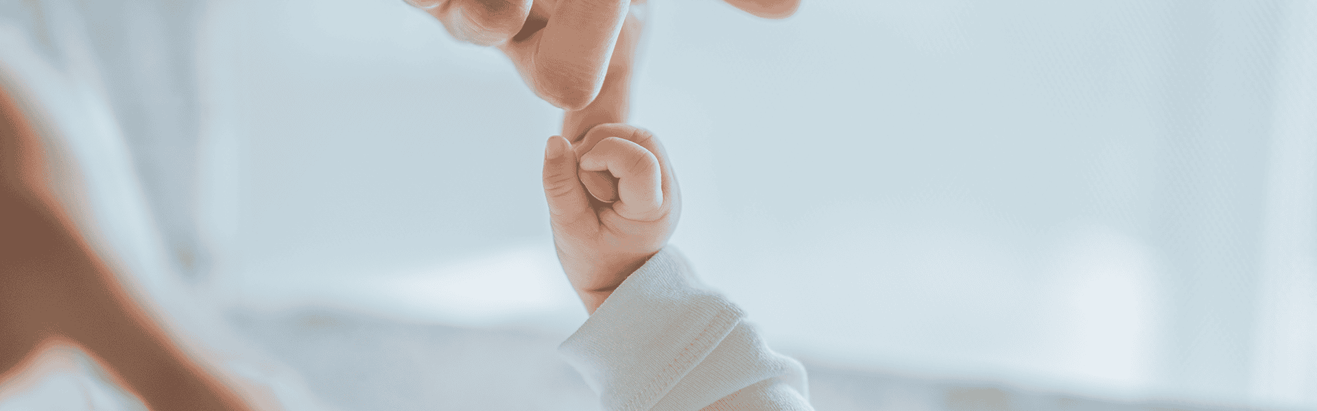 Little hand of child baby holding hand of mother, - Newborn Hearing Screenings Made Easier: Why Did We Never Think of This?