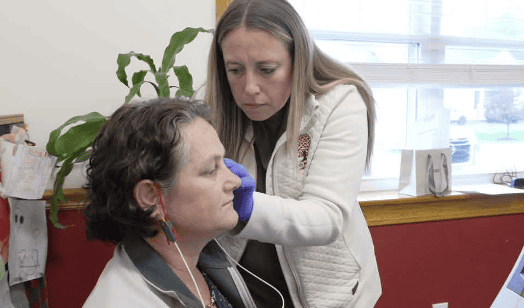Dr. Ashlee Vandiver with Red Maple Audiology in Turner, Maine fits a community member with hearing aids as part of a Day of Giving during Better Hearing and Speech month. The program is through Hearing the Call- Red Maple Roots.