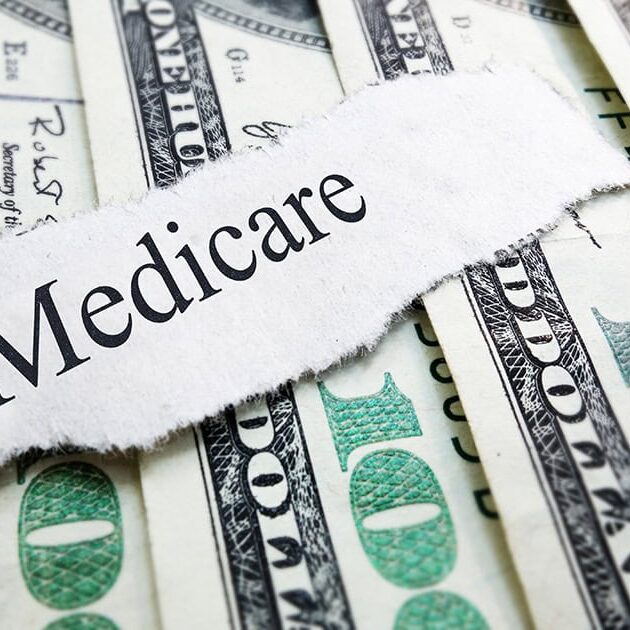 shutterstock_210028999 - social Medicare newspaper headline on assorted money / shutterstock.com