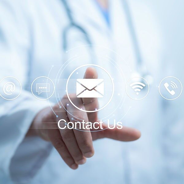 Medical worker using a laptop and touching on virtual screen contact icons email, address, live chat, internet wifi. Contact us or Customer support hotline people connect